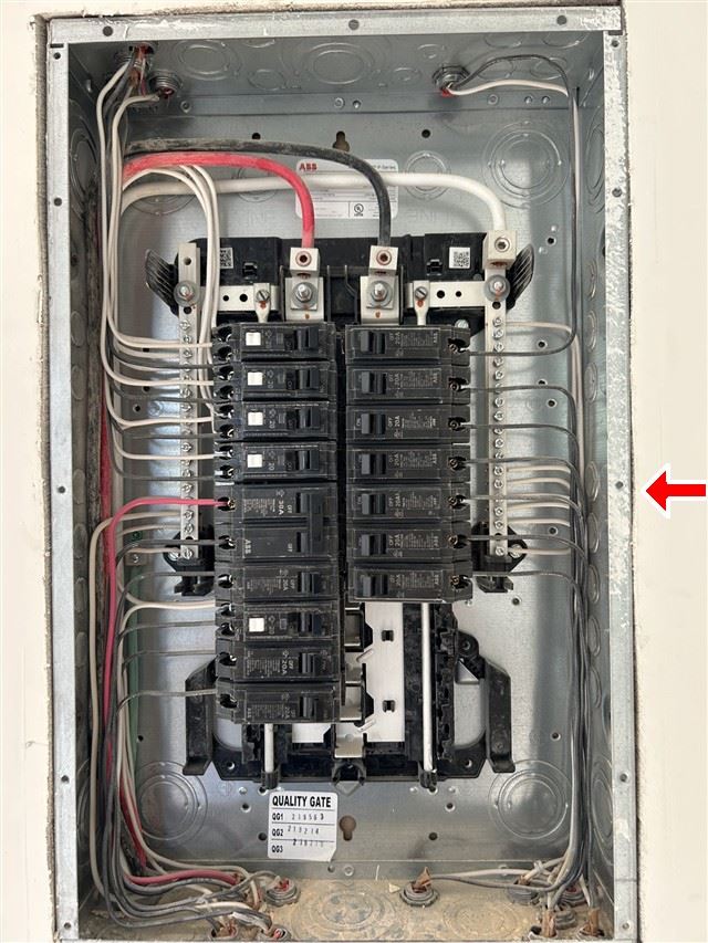 The service panel with its cover off. On a pre-war house this is where the surprises are.