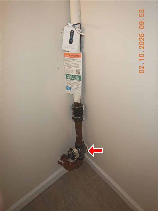 Inspection photograph of a gas service regulator and piping at an interior corner