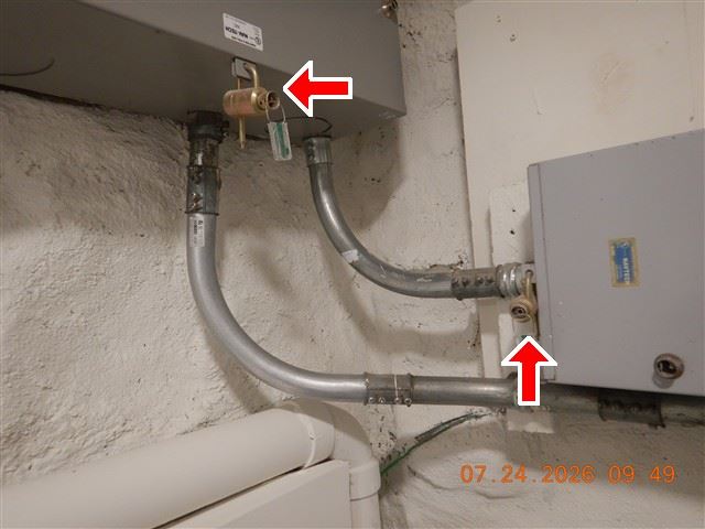 Inspection photograph of a gas shut-off valve and connector at an appliance