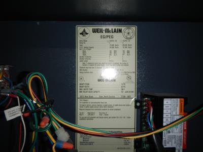 Weil-McLain boiler data plate with control wiring harness in front.