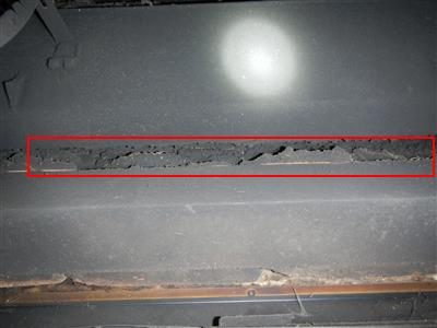Inside of a fireplace with a red rectangle around an open mortar joint along the damper frame.