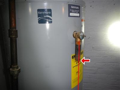 Kenmore water heater with a relief valve on its side, red line and arrow markup.
