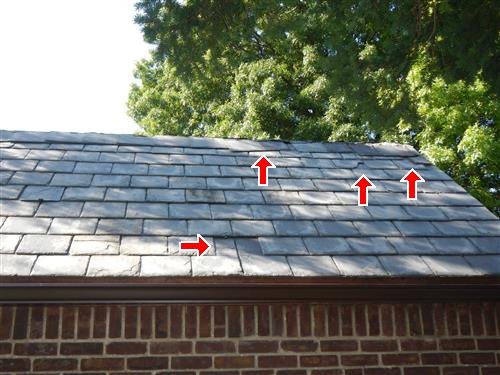 An older grey shingle roof with cracked shingles arrowed beside a dark patched valley.