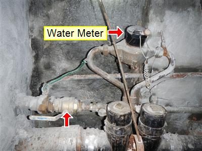 Basement water meter labelled 