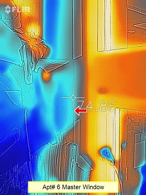 A thermal-camera image of an apartment window and wall showing hot and cold zones in false colour.
