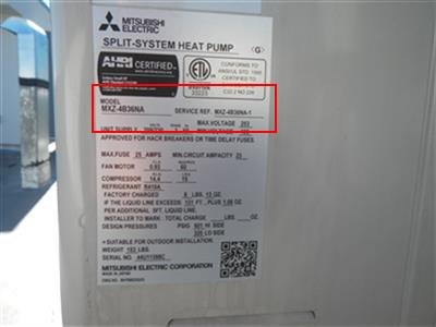 Data plate on a Mitsubishi split-system heat pump with the model number boxed in red