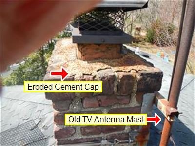 Top of a brick chimney with a crumbling cement cap and a metal antenna mast beside it, with red arrows and report labels.