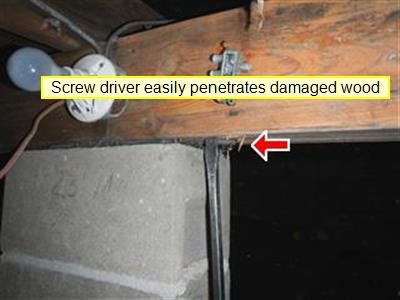 Wood house beam on a concrete block column, red arrow at the bearing point, labelled 