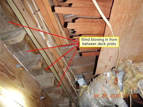 Underside of deck joists with gaps between boards, red lines labelled 