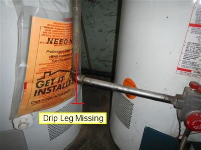 Gas pipe entering a water heater control with a red line and the label 